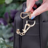 Antitheft water resistant Verona crossbody with zipper clasps. Demonstration of how to clasp the zipper pull clasp onto the bag's d-ring to secure it close and deter pickpockets 