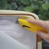 Anti-theft water resistant Crissy Full Crossbody. Demonstration of Slash resistant lining with box cutter