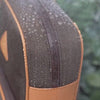 Anti-theft Water-resistant Carmel Backpack and Crossbody demonstrating water-resistant zippers with water droplets falling down the bag